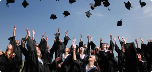 Graduates celebrate their success by throwing their caps high into the air, marking the end of their academic journey.